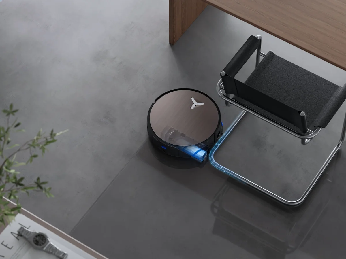 DEEBOT cleaning under an office desk